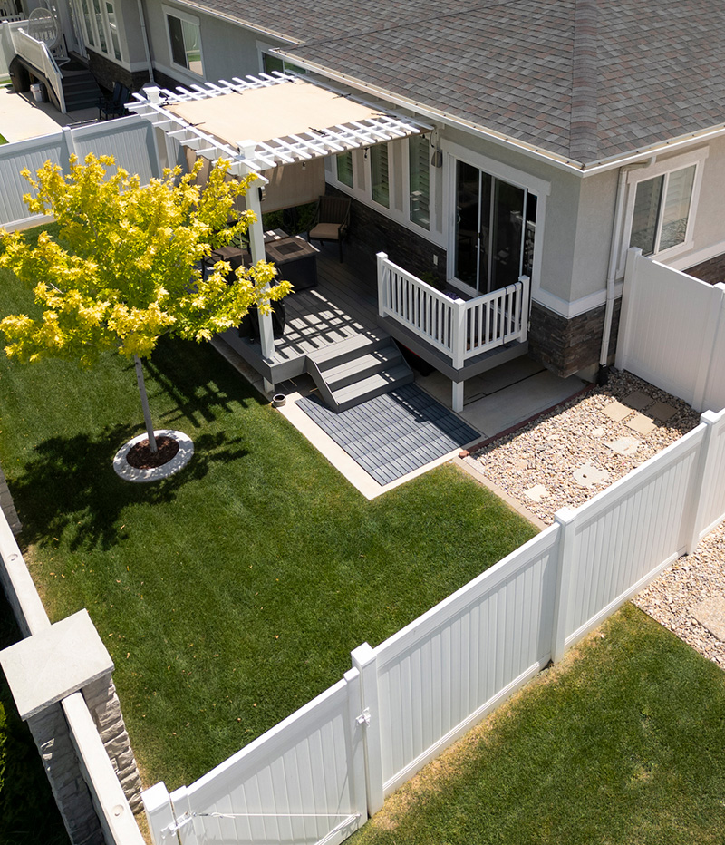 Suburban home background with white vinyl fence aerial view-2159075545 Suburban home background with white vinyl fence aerial view